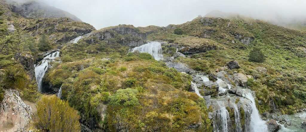 Crystal clear stream with snow capped mountain on the Routeburn Track