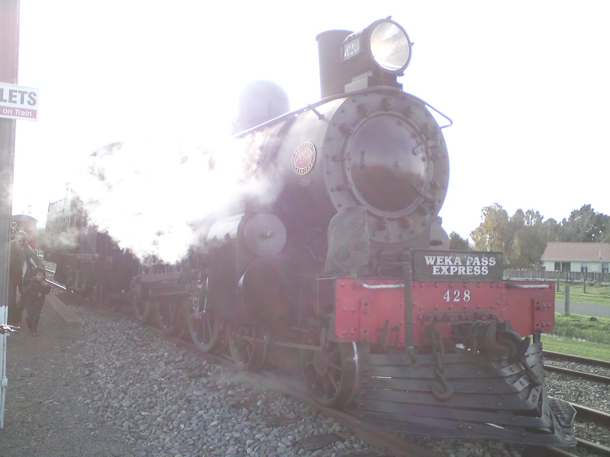 A Class steam locomotive 428 Weka Pass Express with steam billowing at Glenmark Station